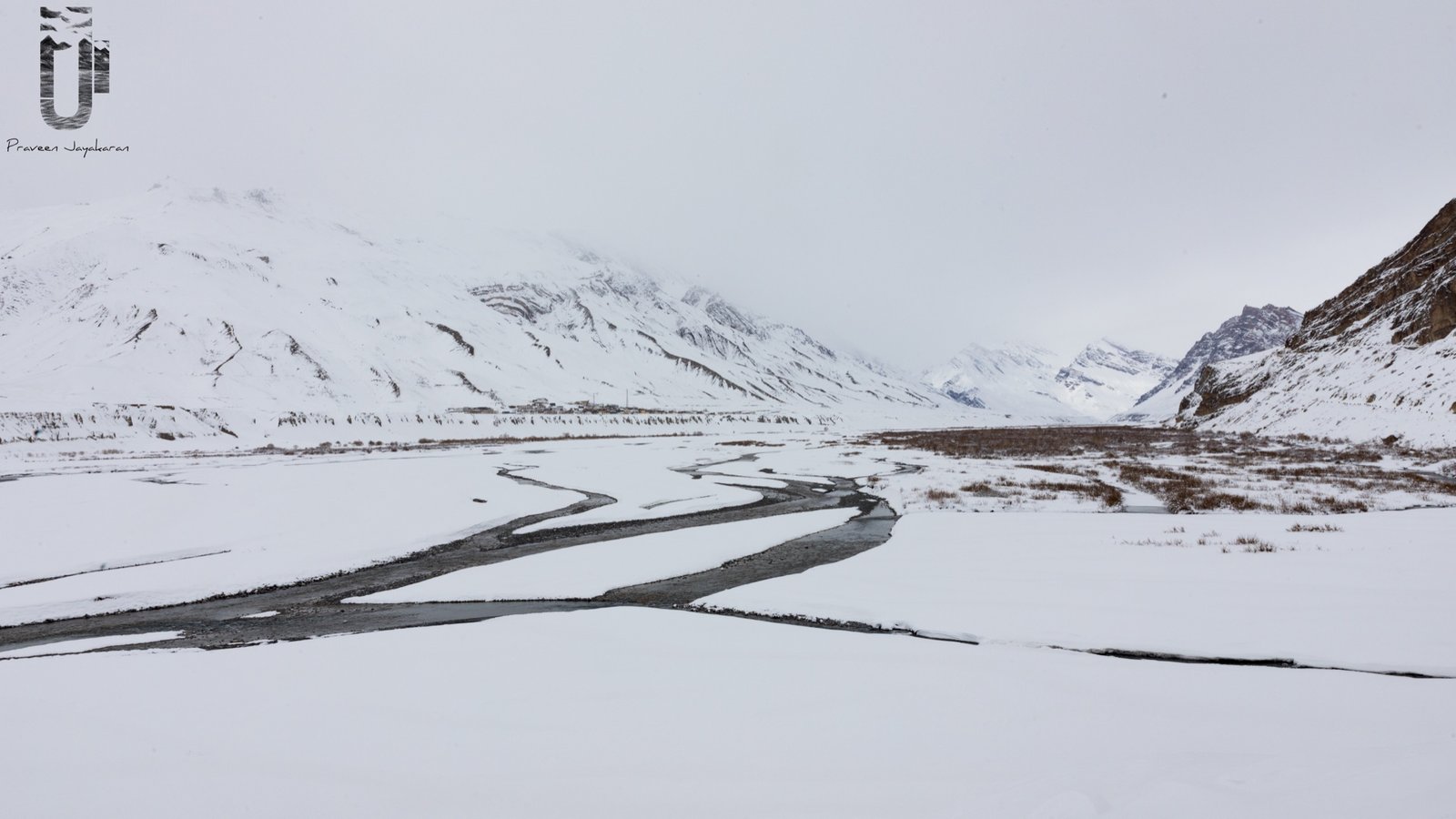 Spiti Valley winter panorama with frozen river and snow-covered mountains